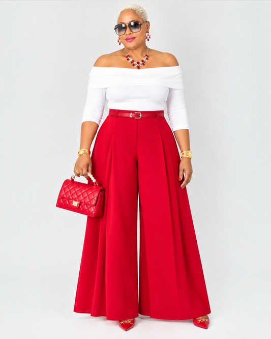 Deon wearing the red pleated wide leg pants with a white off the shoulder tope 